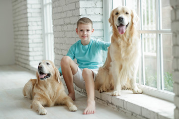 A boy with a dog at home.