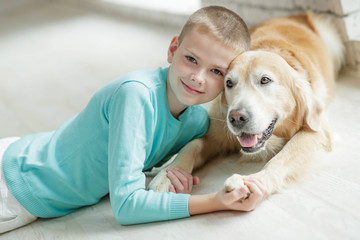 A boy with a dog at home.