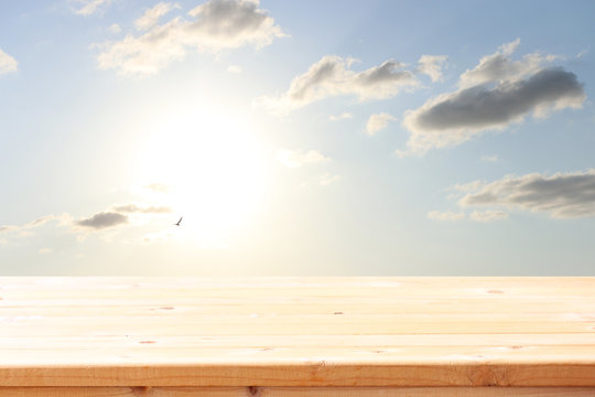 wood board table in front of blue sky. product display background
