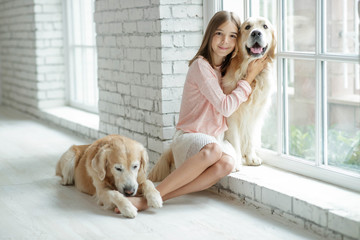 Child with a dog. A girl with labradors at home.