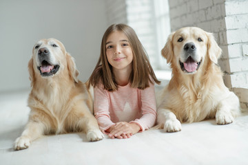 Child with a dog. A girl with labradors at home.
