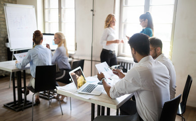 Successful happy group of people learning software engineering and business during presentation