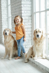 Child girl with dog at home 