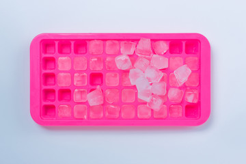 Ice cubes in pink ice tray