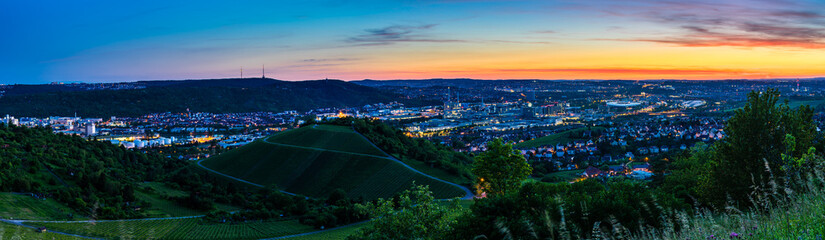 Germany, XXL panorama of downtown stuttgart city, houses and skyline from above in magic dawning atmosphere