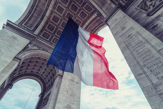 french flag at arc de triomphe during bastille day