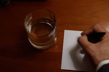glass of water and pills on wooden table