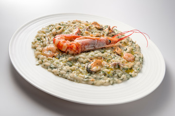 Risotto dish with spinach prawns and seafood