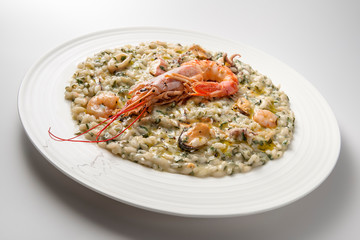 Risotto dish with spinach prawns and seafood