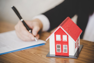 Buying and renting new home concept. Close up of signing rental agreement or sale purchase contract...