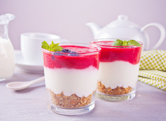 Bowls of breakfast healthy muesli with blueberry, strawberry and yogurt.