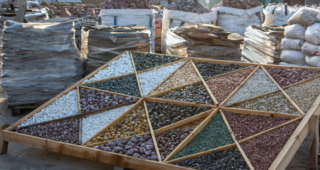 Multi-colored samples of marble, granite, and travertine chips and pebbles for landscape design