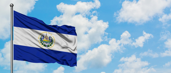 El Salvador flag waving in the wind against white cloudy blue sky. Diplomacy concept, international relations.