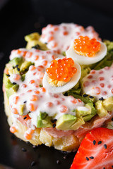 Round salad made of red fish potato and avocado