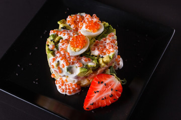 Round salad made of red fish potato and avocado