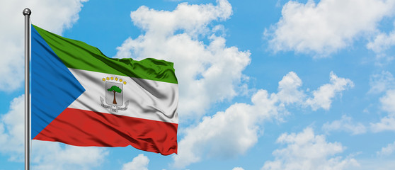 Equatorial Guinea flag waving in the wind against white cloudy blue sky. Diplomacy concept, international relations.