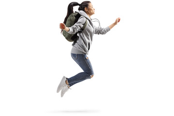 Young female student jumping