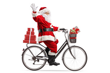 Santa Claus carrying presents on a bicycle and waving
