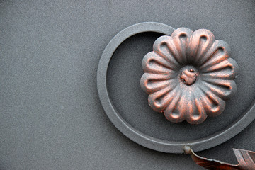  the flower is made of metal on a gray background. blacksmithing