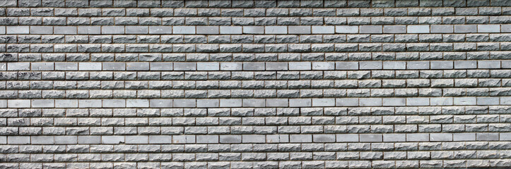 panorama of the gray wall of brick and stone