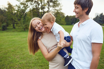 Obraz premium Happy family is laughing in the park.