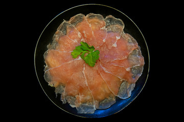 Top view of pork slice put in black plate