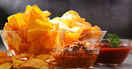 Composition with bowl of potato chips.