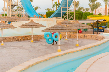 sun beds in popular tropical paradise deep turquoise mediterranean sandy beach. Umbrellas on the beach o Sea in a beautiful summer day