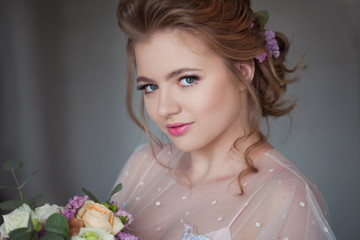 Cute young bride in pink dress. Girl with a wedding bouquet,