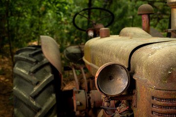 Rusty old tractor with a missing headlight
