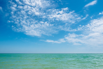 Fototapeta na wymiar Blue turquoise sea and sky clouds