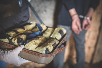 Police arrest drug trafficker with handcuffs. Law and police concept.  World Anti-drug Day