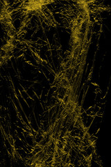 Transparent yellow plastic wrap on the black background. Plastic shopping bag texture. Reusable trash and waste.