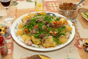 Stewed potatoes with meat on the holiday table