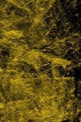 Transparent yellow plastic wrap on the black background. Plastic shopping bag texture. Reusable trash and waste.