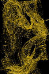 Transparent yellow plastic wrap on the black background. Plastic shopping bag texture. Reusable trash and waste.