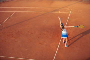 Woman playing tennis on clay court, with sporty outfit and healthy lifestyle