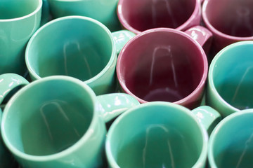 Many colorful empty ceramic cups in store, Mugs background