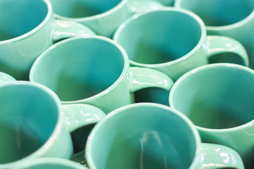 Many colorful empty ceramic cups in store, Mugs background