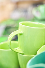 Many colorful empty ceramic cups in store, Mugs background
