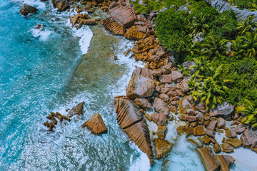Aerial drone photo of stony part of beautiful anse cocos beach at La Digue, Seychelles