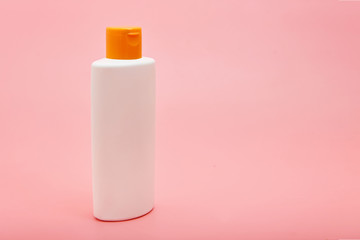 blank white squeeze bottle plastic tube on pink background copy space
