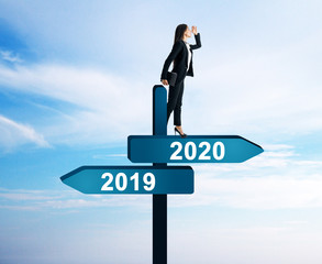 Businesswoman on 2019, 2020 sign