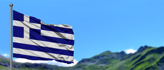 Obraz premium Greece flag waving in the blue sky with green fields at mountain peak background. Nature theme.