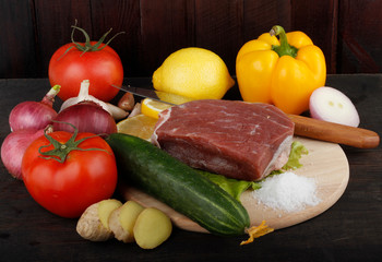 beef with vegetables on wooden background