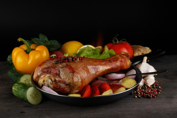 roasted leg of turkey hen on wooden background