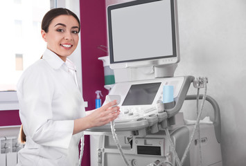 Sonographer using modern ultrasound machine in clinic