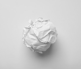 Crumpled sheet of paper on white background, top view