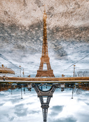 Paris Eiffel Tower's reflection after the rain in Paris, France. Eiffel Tower is one of the most iconic landmarks of Paris.