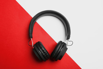 Fototapeta na wymiar Stylish headphones on color background, top view